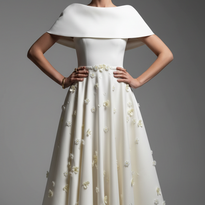 Woman wearing a white dress with a large collar against a gray background