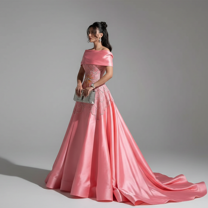 Woman wearing a pink evening gown against a gray background