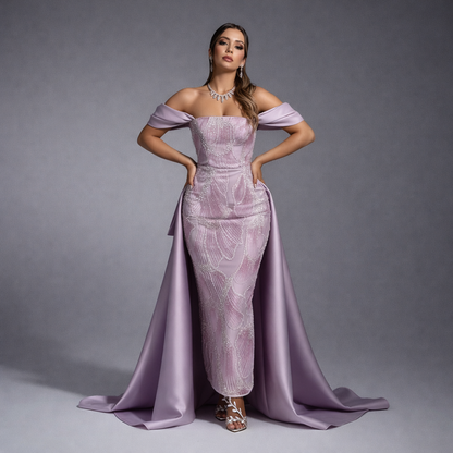 Woman wearing a lavender evening gown with a long train on a gray background