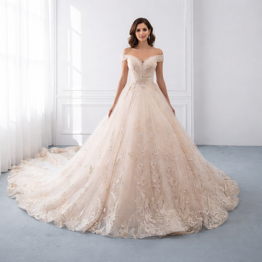 Woman wearing a beige off-shoulder wedding dress in a bright room.