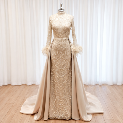Gold evening gown with long train on a mannequin against a white curtain background