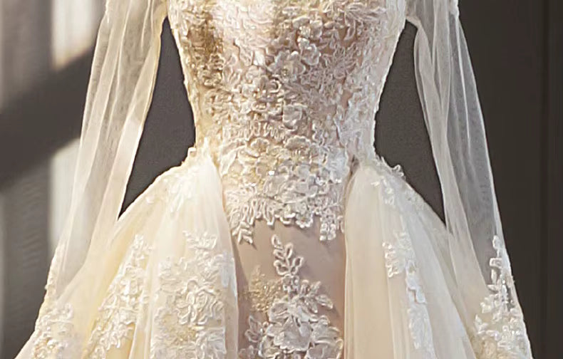 Close-up of a lace wedding dress with a soft focus background