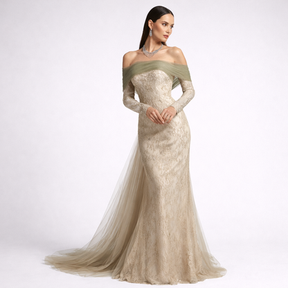 Woman wearing a long, elegant dress with a green bodice on a white background