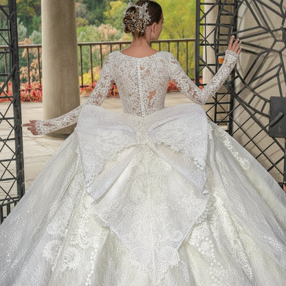 Woman in a white lace wedding dress with a scenic background