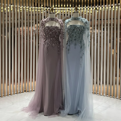 Two evening gowns on mannequins with intricate beadwork against a neutral background.