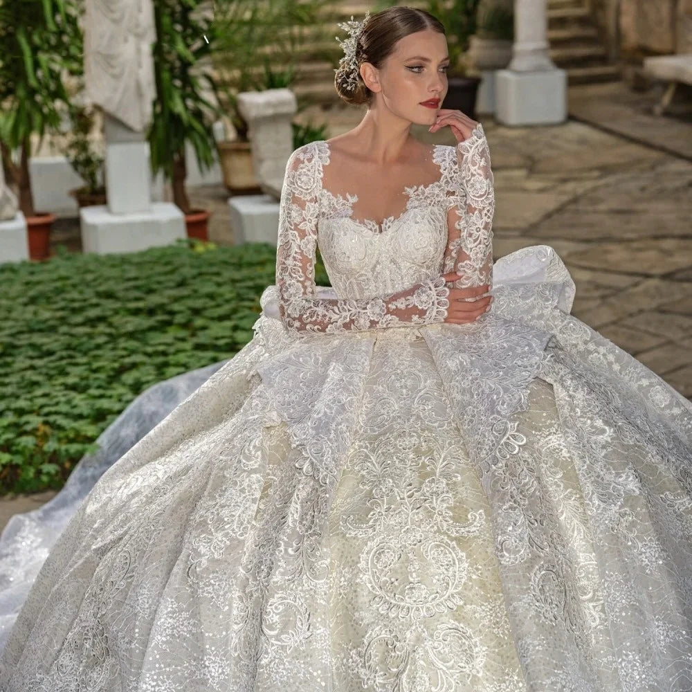 Woman wearing a white lace wedding dress in an outdoor setting.