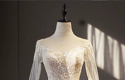 White lace dress on a mannequin against a dark background