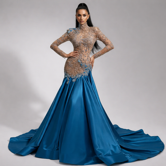 Woman wearing a blue evening gown with intricate detailing on a gray background