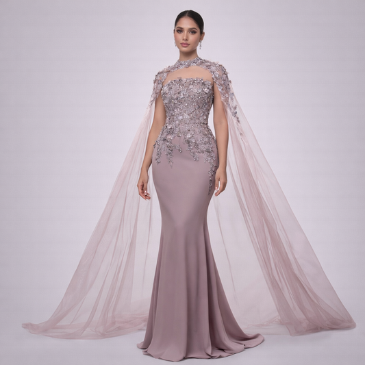 Woman wearing a glamorous evening gown with a cape on a white background