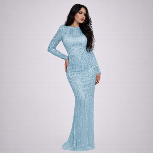 Woman wearing a light blue dress with long sleeves on a white background